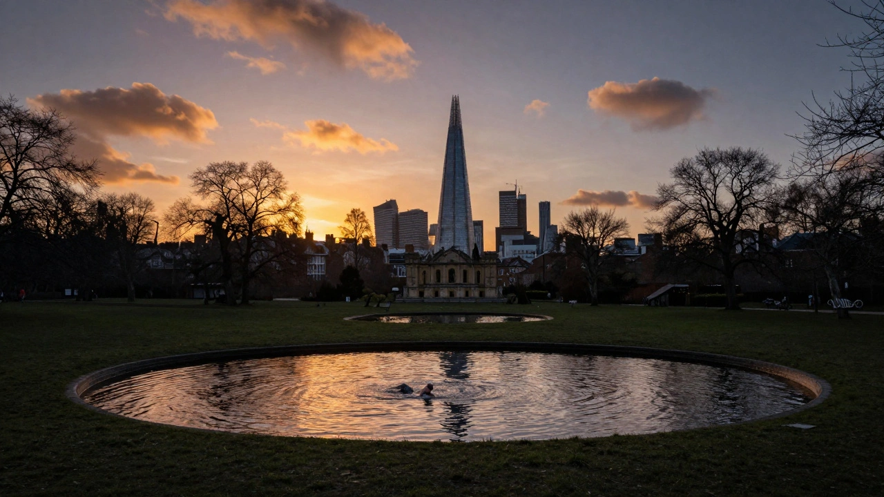 Sunset view over London from Parliament Hill on Hampstead Heath with swimming ponds below.